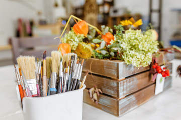 Art workshop with artistic brushes and flowers