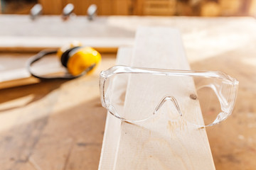 Safety protective headphones and glasses in carpentry, Construction tools and equipment concept