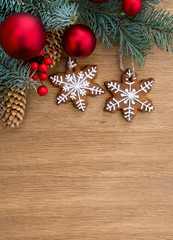 Christmas tree with Christmas balls, christmas gingerbread and cones spruce on a wooden background with space for text. Top view, flat lay
