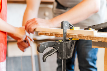 carpenter working with wood, close up on hands