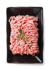 Raw meat. Minced pork in a plate isolated on white background