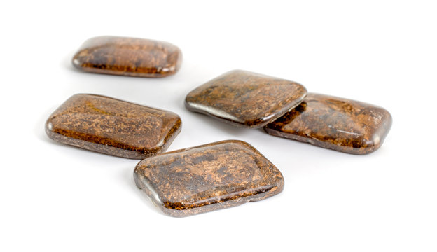 Five pieces cabochon cut bronzite stones isolated on white background