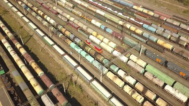 aerial top view of industrial cargo trains on a railway tracks