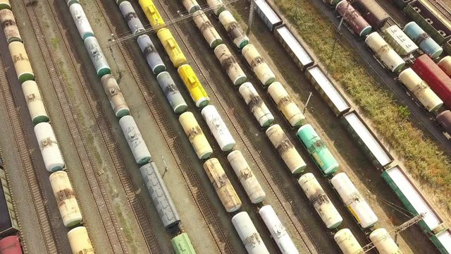 aerial top view of industrial cargo trains on a railway tracks