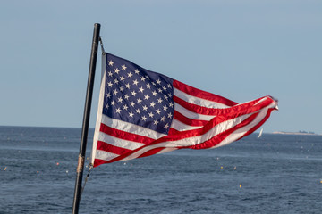 Naklejka premium Flag flying on a ship in a gusty wind