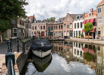Traditional wooden sailing ships in water channel. Old historic harbor of Schiedam, The Netherlands © Oleksandr