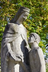 Statue of Maria and a young man looking at her confidently