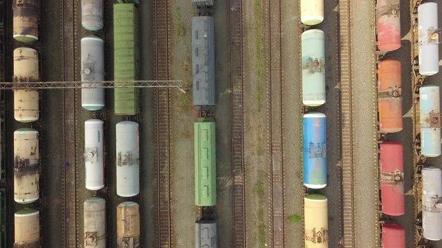 aerial top view of industrial cargo trains on a railway tracks