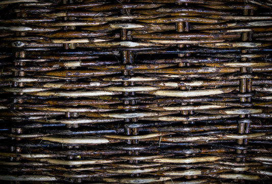 Textured lattice background, old wicker fence of willow twigs. Abstract background.