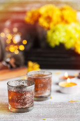Glasses with lit candles and tea pot