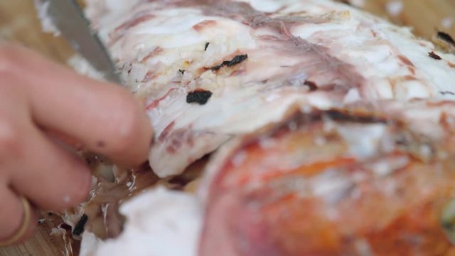 Taking bones out of a freshly grilled fish, Close Up Detail Shot