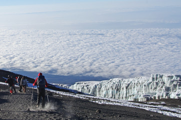 Les gens marchent au sommet du Kilimandjaro en Tanzanie au-dessus des nuages