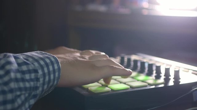 young male sound engineer working in professional music studio with modern equipment recording new track
