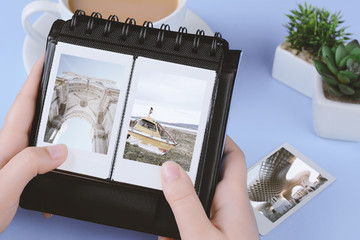 Photo album with instant photos of landscapes