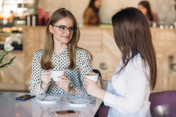 girls use their break from work to drink coffee and chat