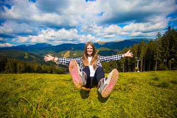 Happy hiker with hands up, freedom and happiness, achievement in mountains