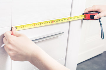 Measuring The Door Size Of A Cupboard With A Measuring Tape