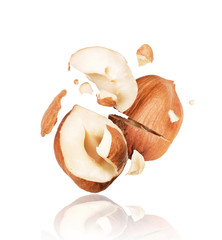 Cracked hazelnut close-up isolated on white background