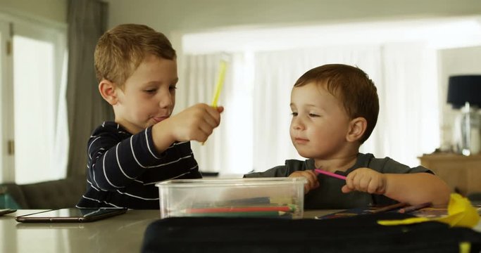 Siblings doing schoolwork in living room 4k