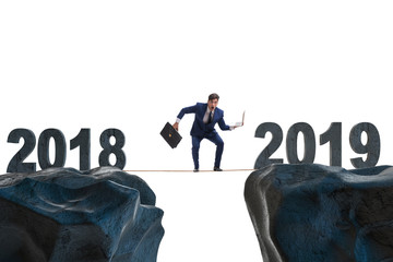 Businessman balancing between 2018 and 2018