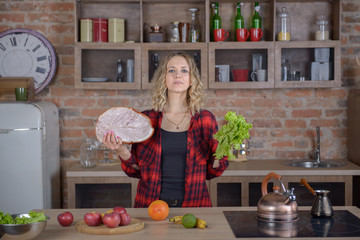 Woman with meat and leaves salad in the kitchen