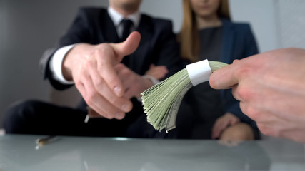 Happy couple receiving money in cash from buyer, successful deal, investment
