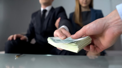 Couple giving bribe for illegal deal on real estate market, inheritance fraud
