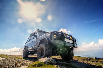 Jeep car adventure on top of Mountain Petros in the Ukrainian Carpathians - obrazy, fototapety, plakaty