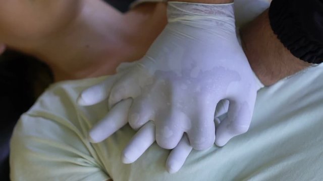 Doctor doing cardiopulmonary resuscitation to female in ambulance, reanimation