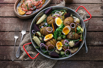 Baked potatoes, carrots, green beans and eggs.