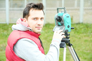 Civil engineer land survey with tacheometer or theodolite equipment. Worker Checking construction...