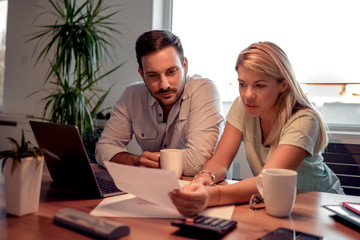 Couple checking their bills at home