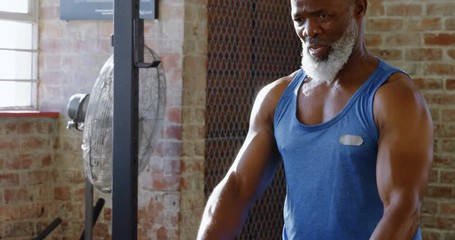 Senior man doing crossfit rope training in the fitness studio 4k