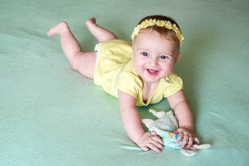 Closeup of happy six months baby boy crawling on colorful playmat