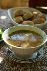 Traditional Azerbaijan dushbere soup with meat dumplings and fresh vegetable sliced tomatoes, cucumbers and pita bread