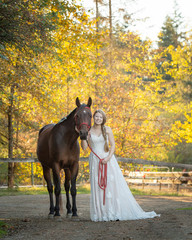 Bride and her horse standing together