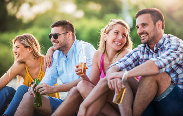Group of friends enjoying picnic on the beach. Lifestyle, vacation, relationships concept