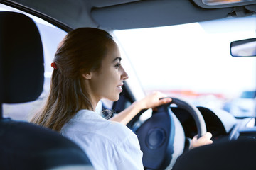 back view a woman driver in the car
