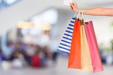 Woman with shopping bags and card on