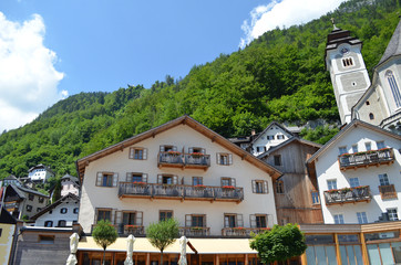 Picturesque view of town with beautiful buildings near mountain forest
