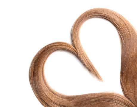 Heart made of brown hair locks on white background