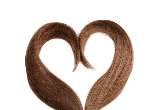 Heart made of brown hair locks on white background