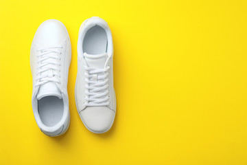 Pair of sneakers on color background, flat lay. Space for text