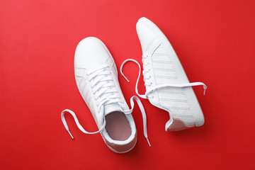 Pair of sneakers on color background, flat lay