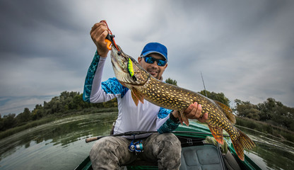 Fishing. Fisherman and trophy Pike.