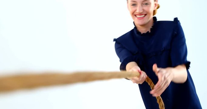 Woman pulling a rope tug of war 4k