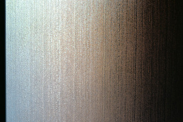 Soft colored light coming from a window and filtered through a glass plate