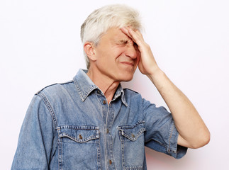 lifestyle, health  and people concept: Senior man has headache