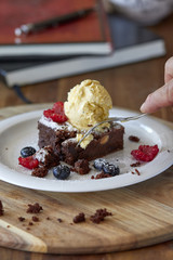 Chocolate brownie with a scoop of ice cream on top 