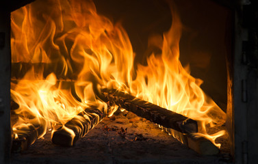 Close up of roaring fire burning brightly in fireplace. Warmth in winter time.